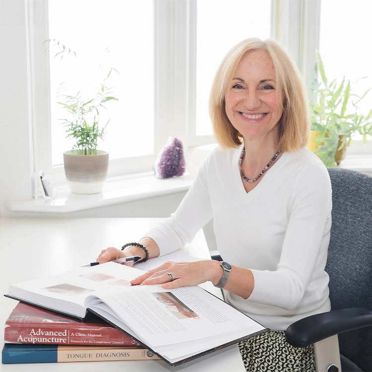 Lisa Gordon sitting at a desk with an open book